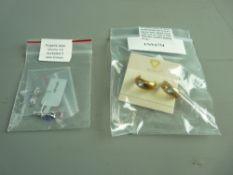 A PAIR OF NINE CARAT GOLD HALF HOOP EARRINGS, each with a tiny round cut blue topaz set and a pair