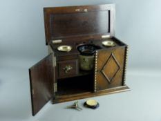 A VINTAGE OAK SMOKER'S CABINET with decorative front moulding and lidded top opening to reveal a