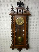 A WALNUT CASED PENDULUM DRIVEN VIENNA STYLE WALL CLOCK, the dial set with Roman numerals and