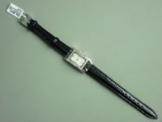 A LADY'S OBLONG DIAL QUARTZ WHITE METAL FRAMED DRESS WATCH, with forty tiny diamonds and with