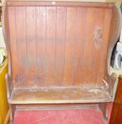 A 19th CENTURY SCUMBLED PINE OPEN TALL SETTLE, the high back flanked by shaped sides with solid seat