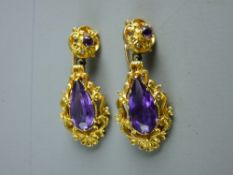 A PAIR OF BELIEVED NINE CARAT GOLD PEARDROP AMETHYST EARRINGS, the peardrop stones in an