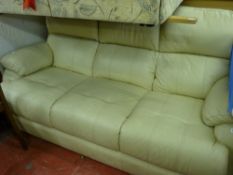 Light coloured leather effect three seater sofa and matching armchair