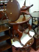Three similar patterned occasional tables, one with magazine holder
