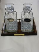 Pair of presentation 'Whisky' and 'Sherry' decanters on a stand with silver labels