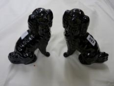 Pair of black Jackfield pottery type seated spaniels