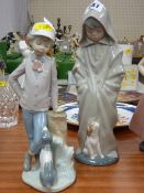 Nao figurine of boy with dog and hooded girl with puppy