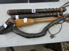 Two police truncheons, a light wood baton or club and a stick wood club