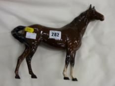 Beswick pottery brown horse, head with white mane inclined to right, white front ankles, tail