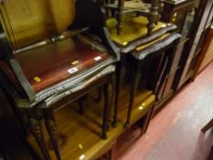 Two sets of leather topped nests of tables