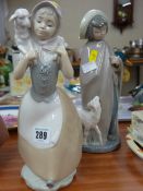 Nao figurine of girl with lamb on shoulder and a Nao figurine of a girl with lamb