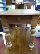A stripped rectangular topped kitchen table with end drawer on turned tapering supports