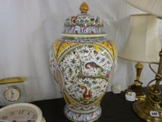 A multi-coloured garden life decorated baluster vase with lid
