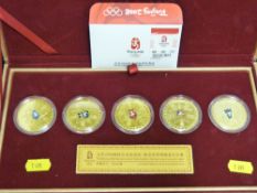 A cased presentation set of limited edition gold plated coins for the Beijing 2008 Olympic games