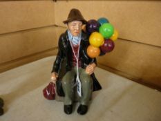 A Royal Doulton pottery seated figurine 'The Balloon Man' HN1954