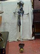 A heavy duty petrol grass trimmer with supports