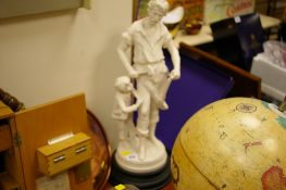 A large composition figure of a blacksmith with child