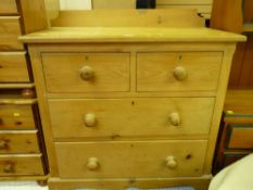 A vintage stripped pine chest of two short over two long drawers