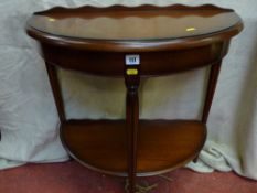 A reproduction mahogany half moon hall table with under tier shelf