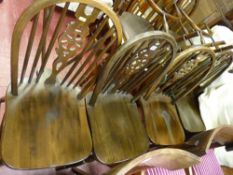 A set of four wheel backed dining chairs