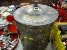 A beaten brass coal bucket with lid