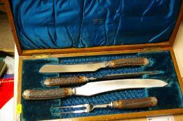 A wooden boxed four-piece carving set by The Murfin Brothers of Sheffield