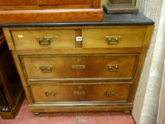 A continental walnut chest of two short over two long drawers with black granite top