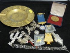 A signs of the zodiac brass tray containing mixed collectables, pendants, coins etc