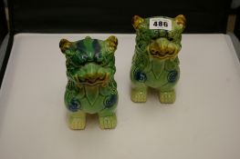 A pair of Dogs of Foo porcelain ornaments