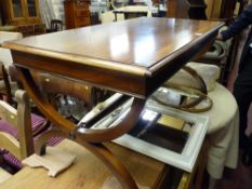 A reproduction mahogany coffee table with X frame supports