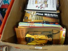 A box of auction catalogues, many featuring good toys