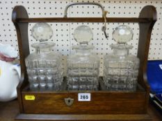 A three-bottle tantalus with key