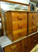 A teak mirror back dressing chest & a pair of matching three-drawer bedside cabinets