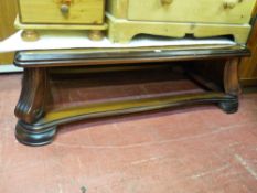 A modern walnut effect coffee table on swept supports