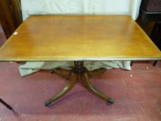 A Victorian mahogany pedestal breakfast table on four splayed supports with brass cups & castors