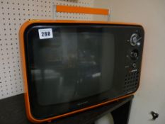 An Hitachi orange coloured solid state retro TV E/T