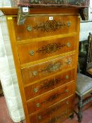 A continental chest of seven drawers, walnut veneered pine carcass with stencilled front decoration