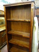 A modern hardwood effect open standing bookcase & a lightwood two-door entertainment cabinet