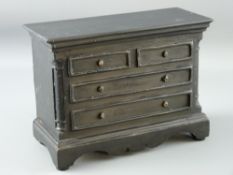 A WELSH SLATE FOLK ART piece in the form of a chest of drawers having blind drawer frontage with