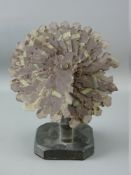 A WELSH SLATE FOLK ART fan shaped sculpture on a shaped stand and square canted corner base, 19.5