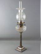 A VICTORIAN OIL LAMP with metal Corinthian column having a clear glass reservoir and clear etched