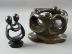 TWO INUIT STONE CARVED FIGURAL GROUPS of a couple in embrace and four people in stylized form with