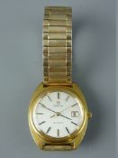 A GENT'S OMEGA YELLOW METAL & STAINLESS STEEL CASED QUARTZ CALENDAR WRISTWATCH with expanding
