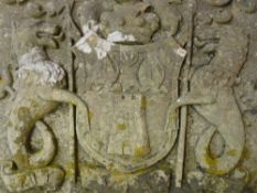 A CONSTITUTED STONE COAT OF ARMS featuring a central shield with castellated tower and mask figure