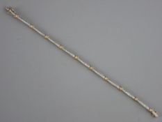A NINE CARAT GOLD BRACELET with open bar and knot links, each inset with tiny diamonds, 18 cms long,