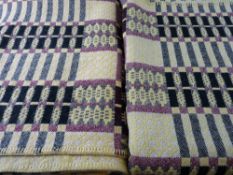 A PAIR OF VINTAGE WELSH WOOLLEN SINGLE BEDSPREADS in patterned yellow, black and red tones