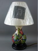 A MOORCROFT 'SIMEON' TABLE LAMP & SHADE, designed by Phillip Gibson, 35 cms high overall