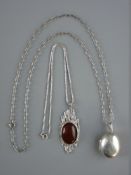 TWO SILVER PENDANTS WITH CHAINS including a bulbous locket stamped 925 on a sterling chain, 35 cms