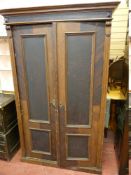 A CONTINENTAL SCUMBLED PINE ARMOIRE, the inverted stepped cornice over twin two panelled doors and