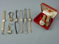 A PARCEL OF SIX UNBOXED LADY'S WATCHES, a yellow metal encased Rotary oval dial lady's watch with